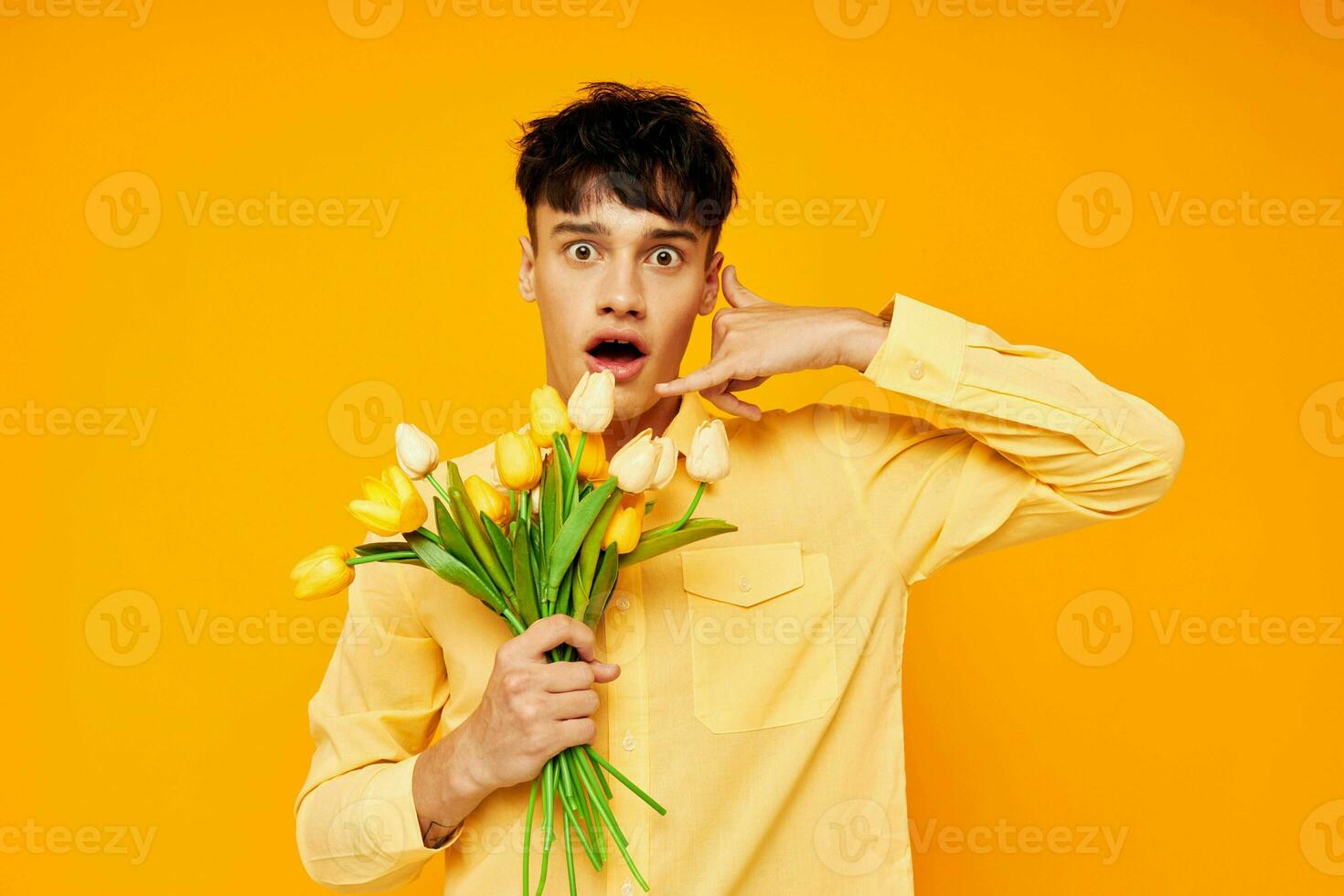 Photo of romantic young boyfriend with a fashionable hairstyle in yellow shirts with flowers Lifestyle unaltered