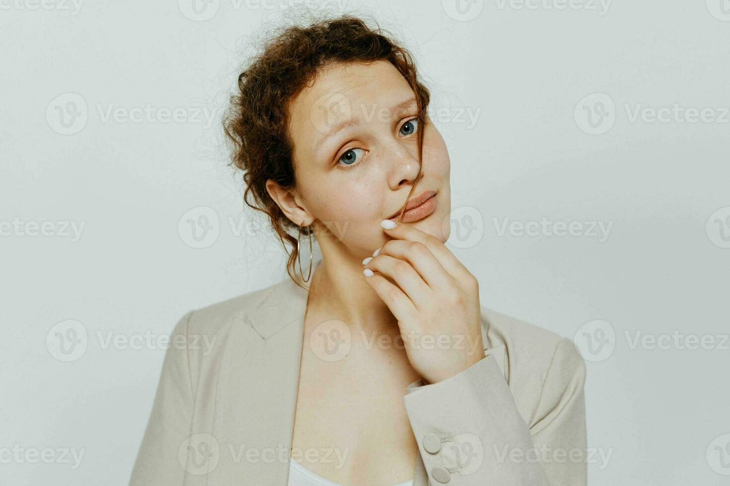 portrait of a young woman in a suit gestures with his hands isolated backgrounds unaltered photo
