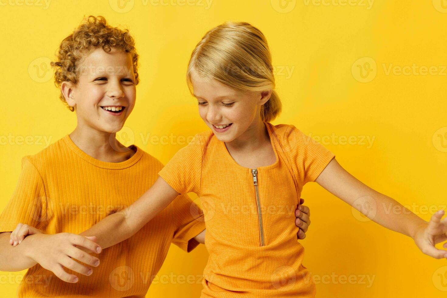 picture of positive boy and girl cuddling fashion childhood entertainment on colored background unaltered photo
