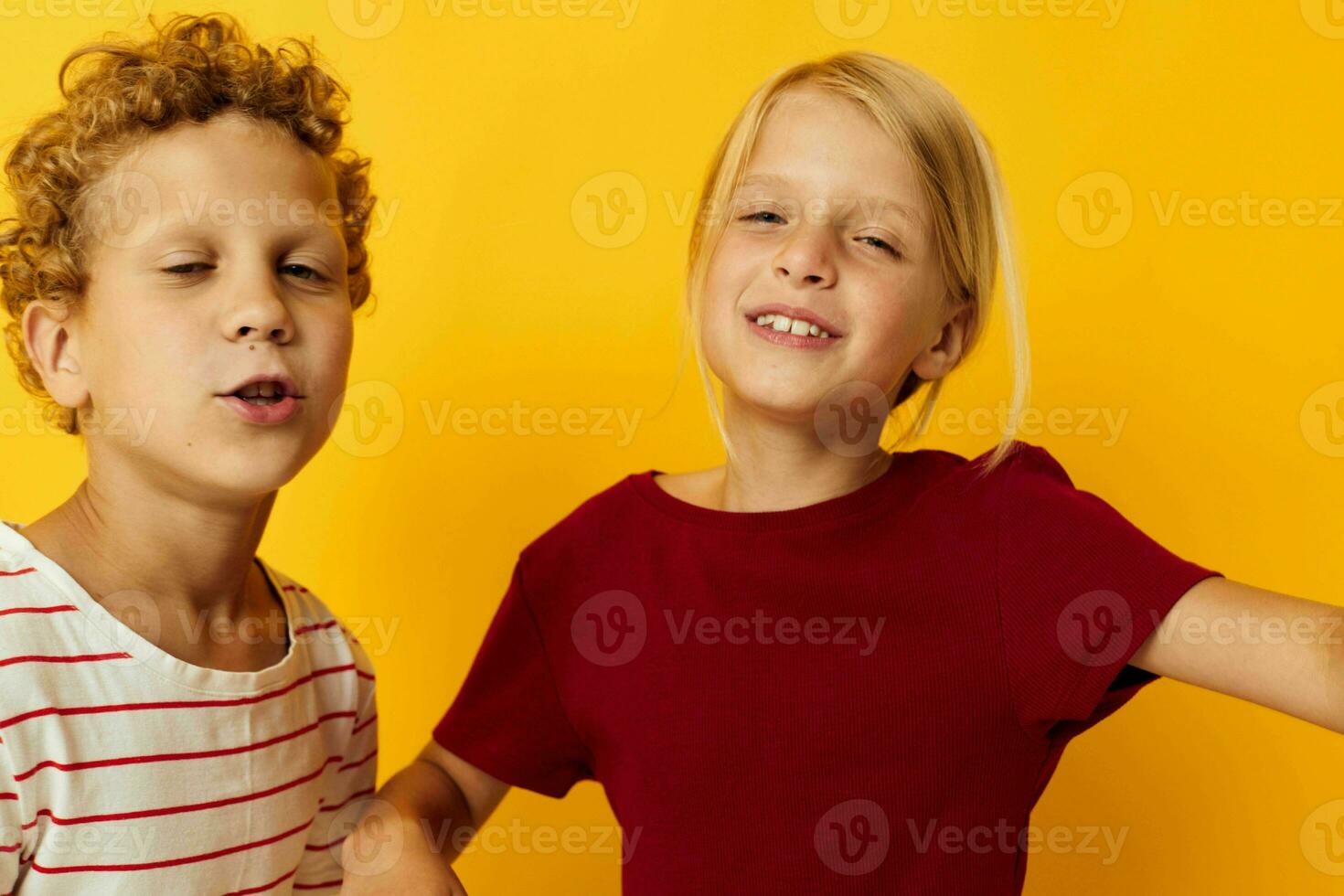 Small children cuddling fashion childhood entertainment on colored background photo