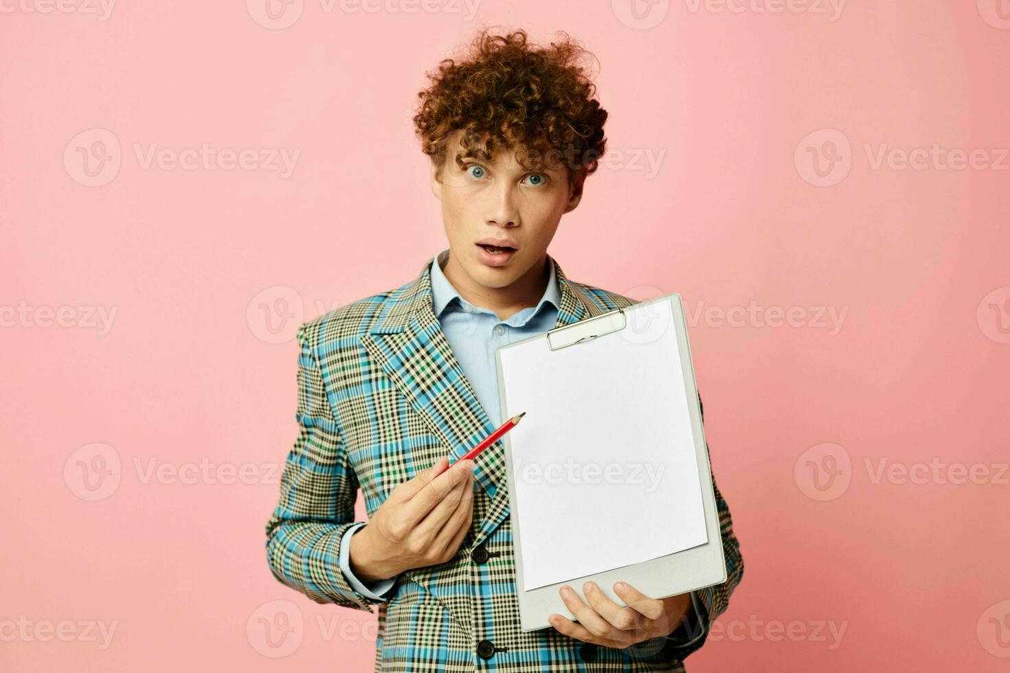 cute red-haired guy in a business suit copy-space documents pink background unaltered photo