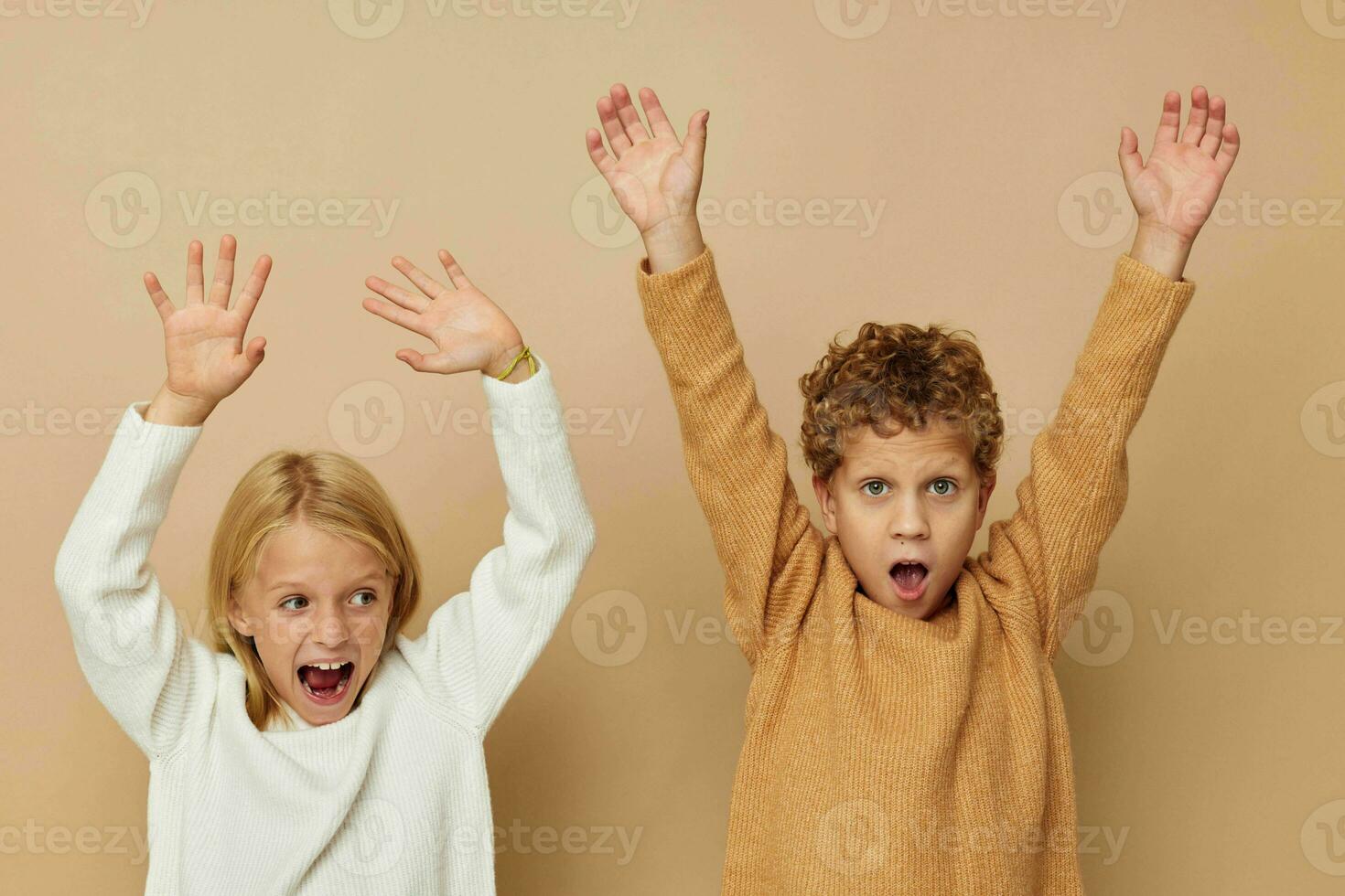 Portrait of cute children in sweaters together fun isolated background photo