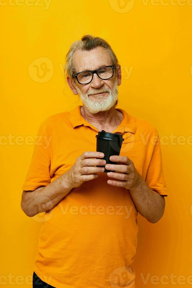 Portrait of happy senior man with black disposable cup isolated background photo