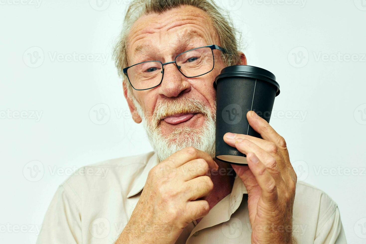 Photo of retired old man with a gray beard in a shirt and glasses light background