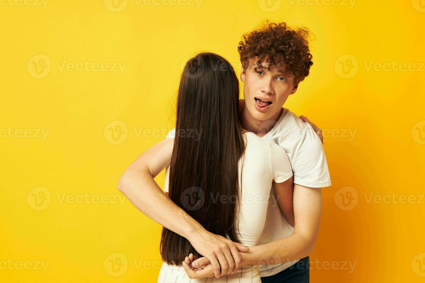 cute young couple stand hugging each other in white T-shirts isolated background unaltered photo