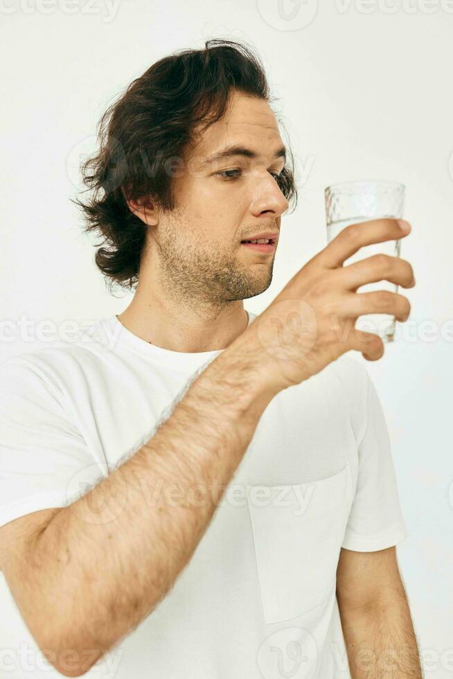 man in a white T-shirt glass of water Lifestyle unaltered photo