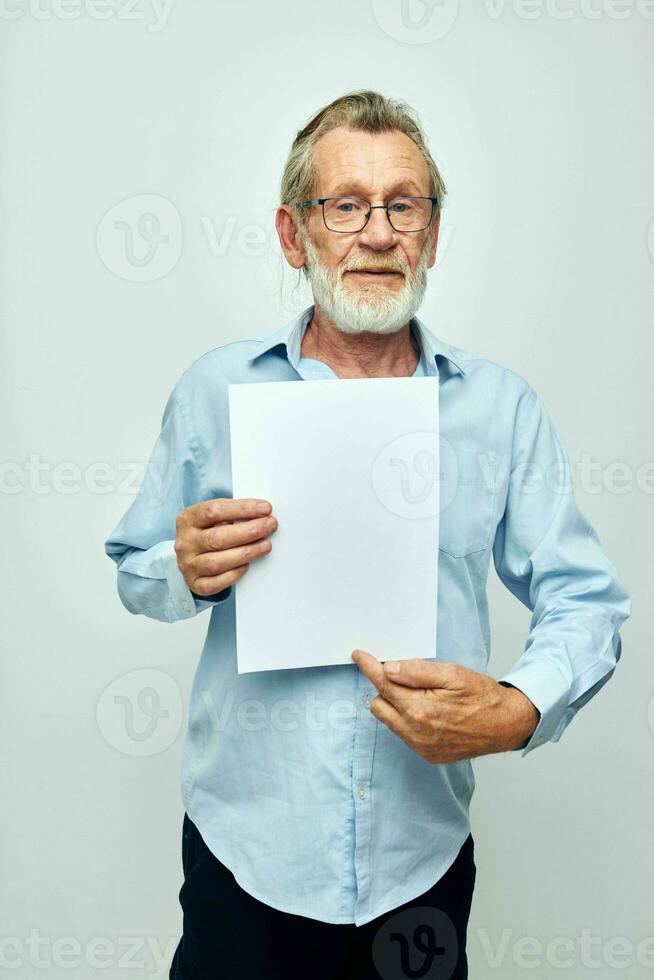 Portrait of happy senior man blank sheet of paper gesture hands smile cropped view photo
