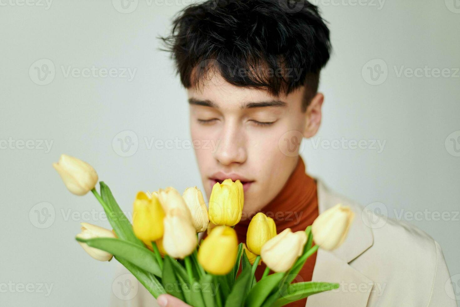 handsome guy self-confidence bouquet of flowers holiday background unaltered photo