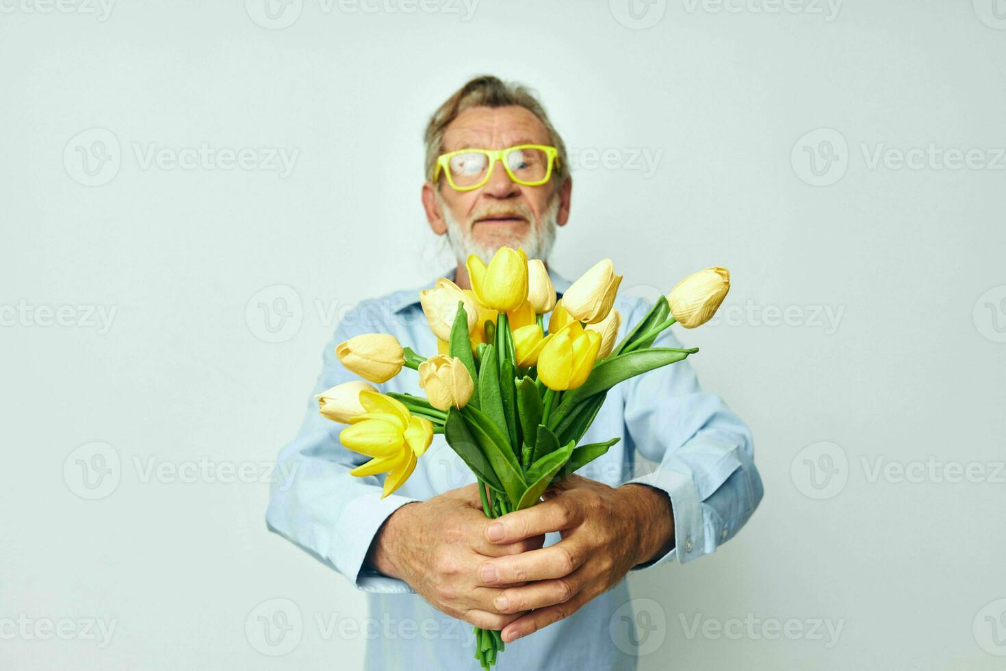 elderly man a bouquet of flowers with glasses as a gift light background photo