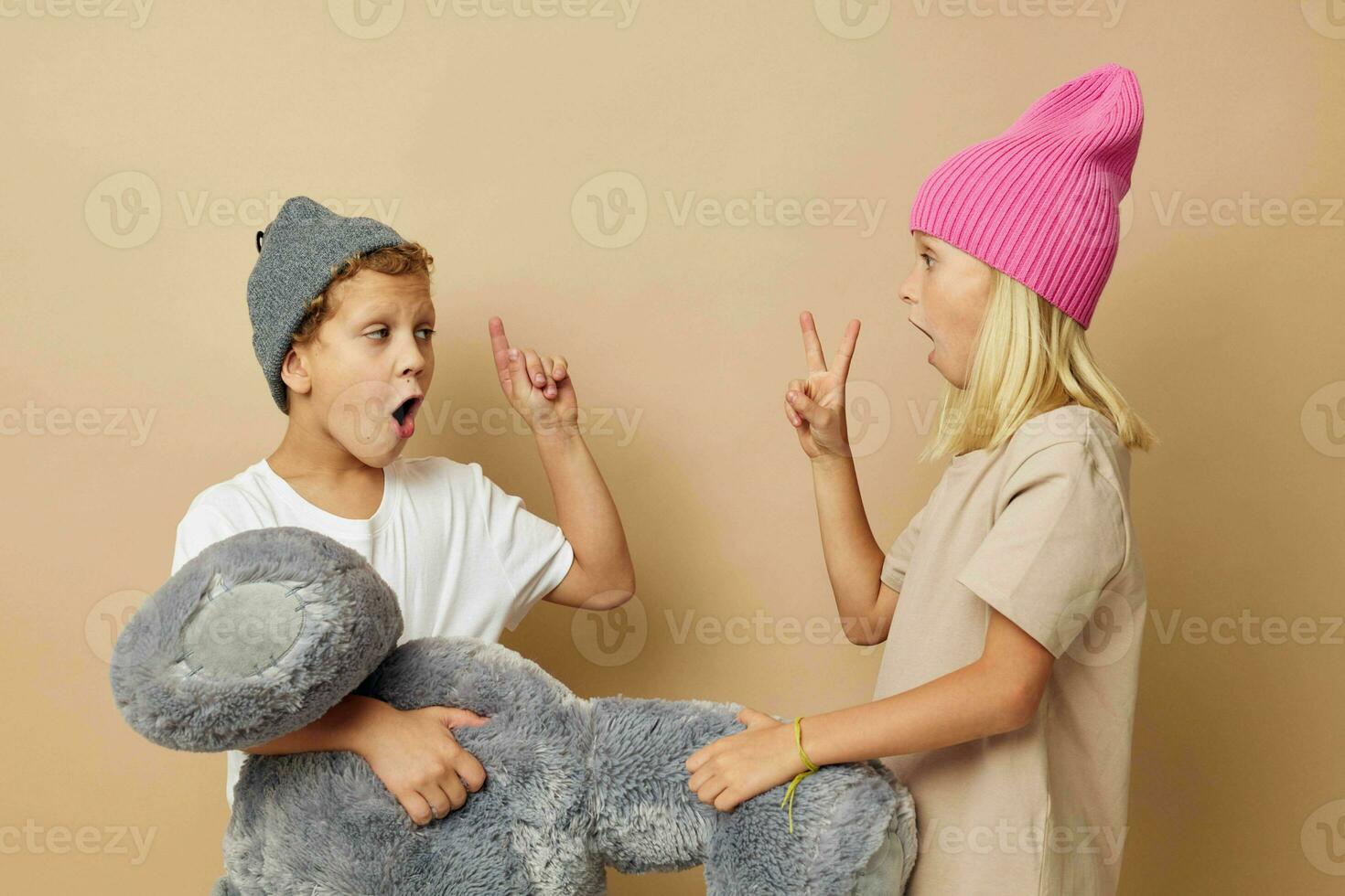 Boy and girl in multi-colored hats entertainment posing isolated background photo