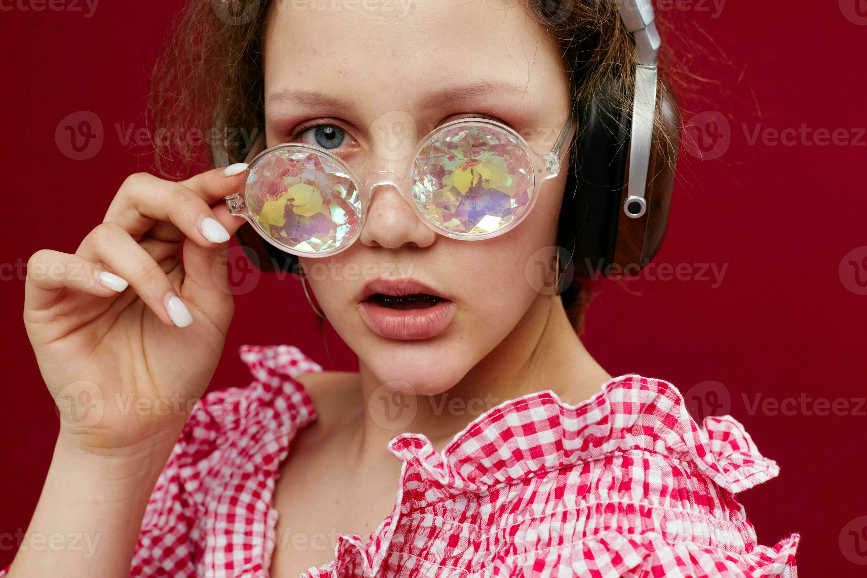girl wearing headphones glasses with diamond closeup red background