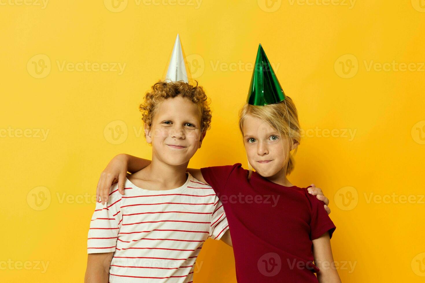 Boy and girl smiling and posing in casual clothes against on colored background photo