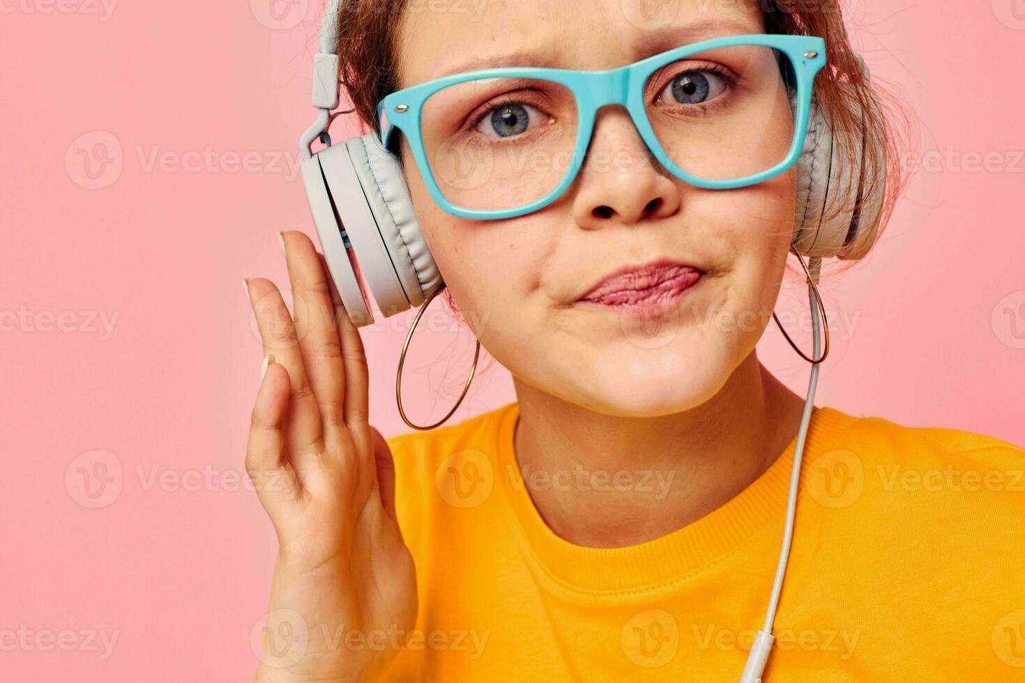 beautiful woman grimace headphones music entertainment technology pink background unaltered photo