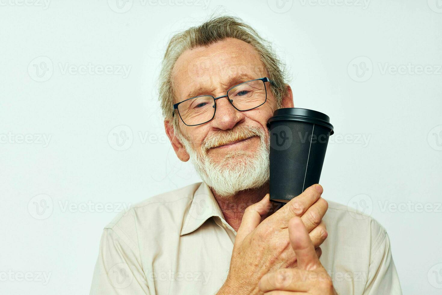 Portrait elderly man with a gray beard in a shirt and glasses isolated background photo