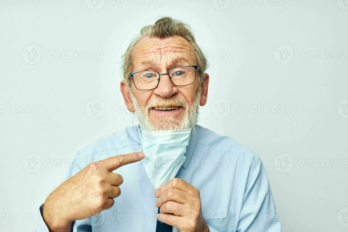 Photo of retired old man medical safety mask health light background