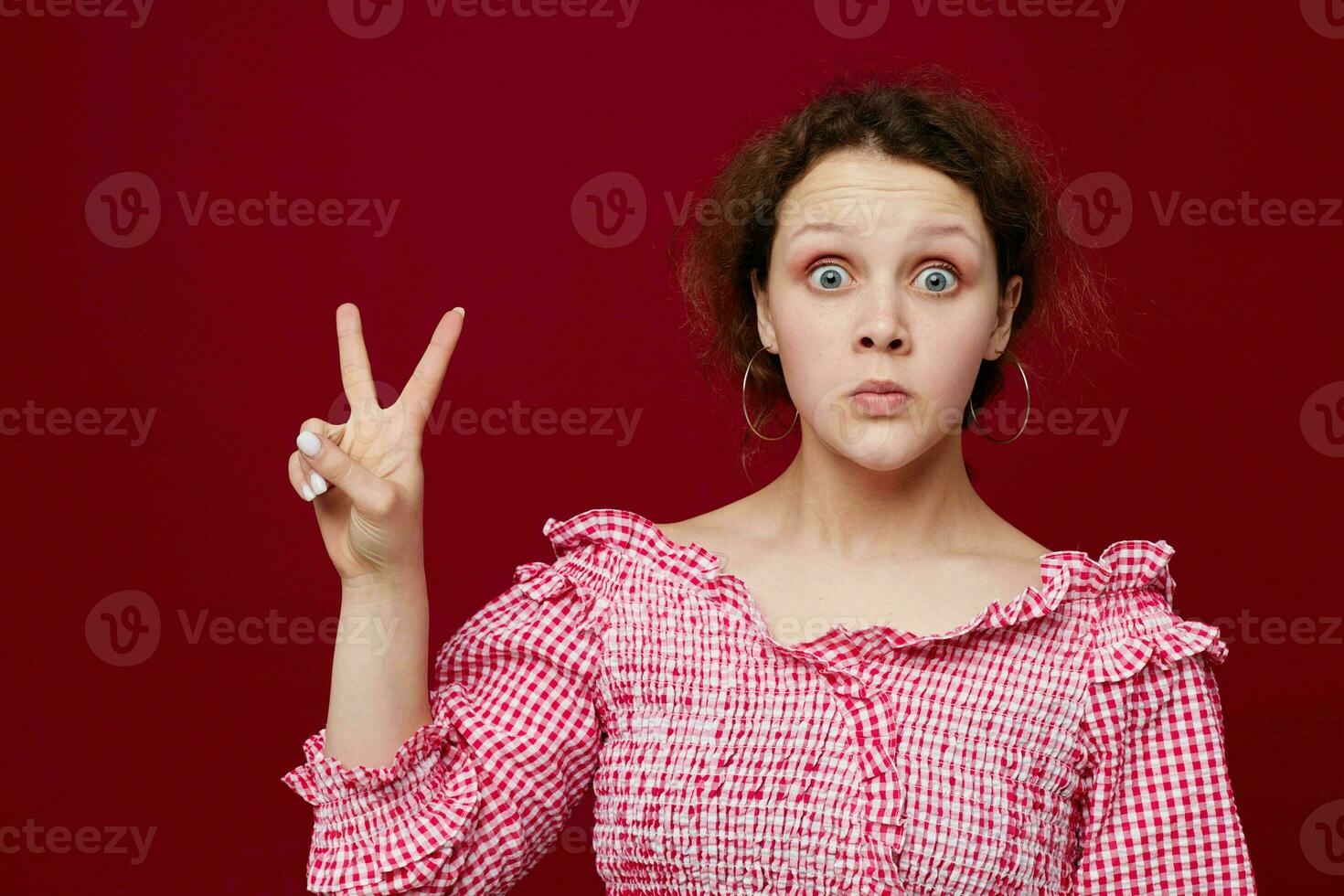 pretty woman in pink shirt posing emotions red background unaltered photo