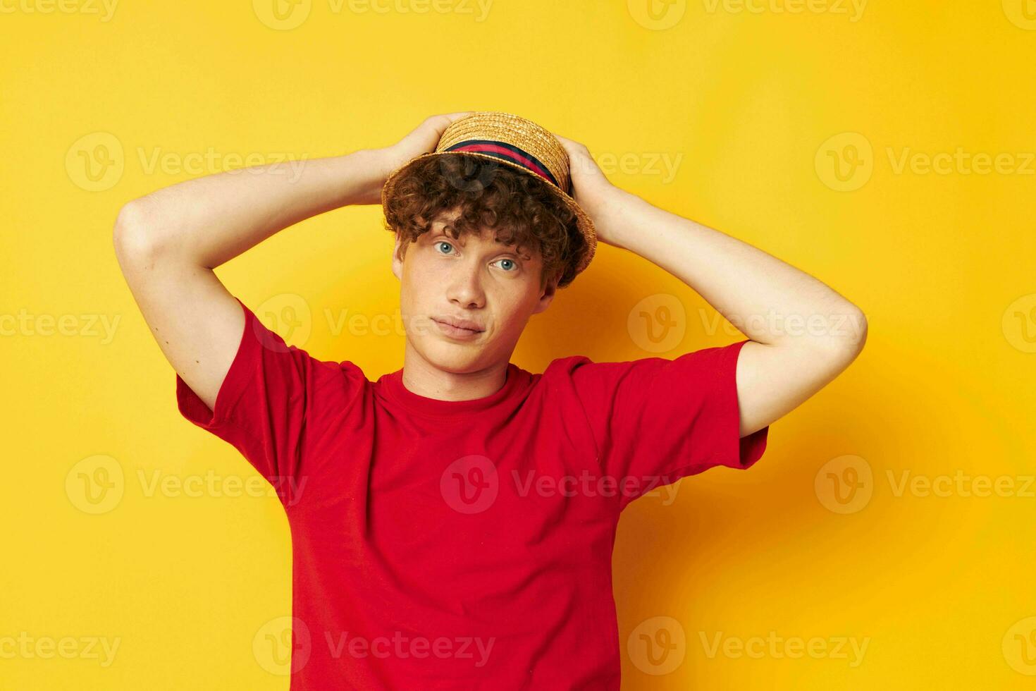 guy with red curly hair emotions red t-shirt hat studio yellow background unaltered photo