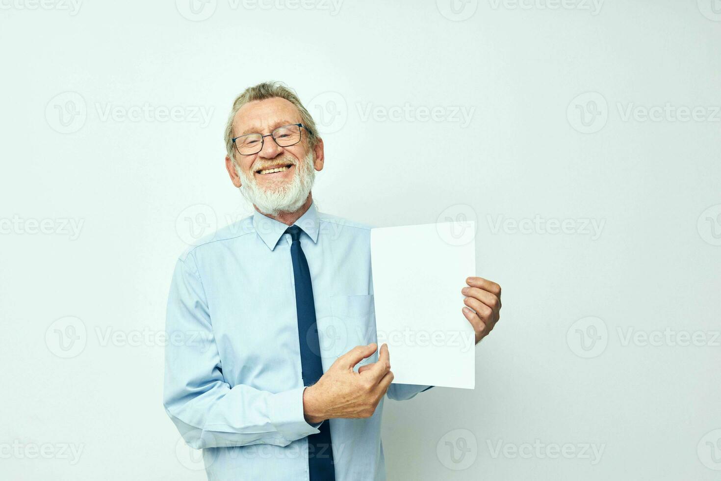 old man holding documents with a sheet of paper light background photo