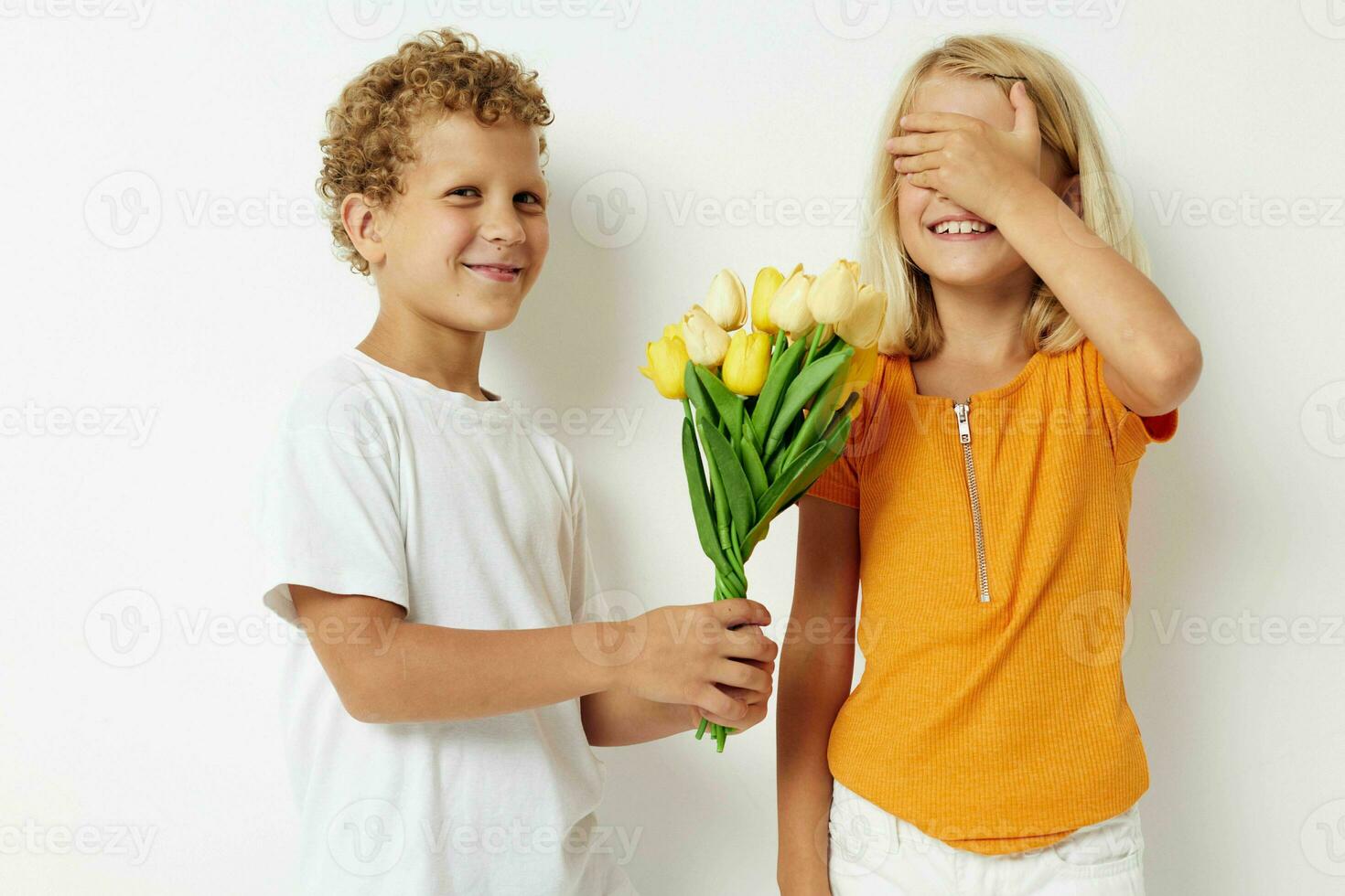 cheerful children fun birthday gift surprise bouquet of flowers isolated background unaltered photo