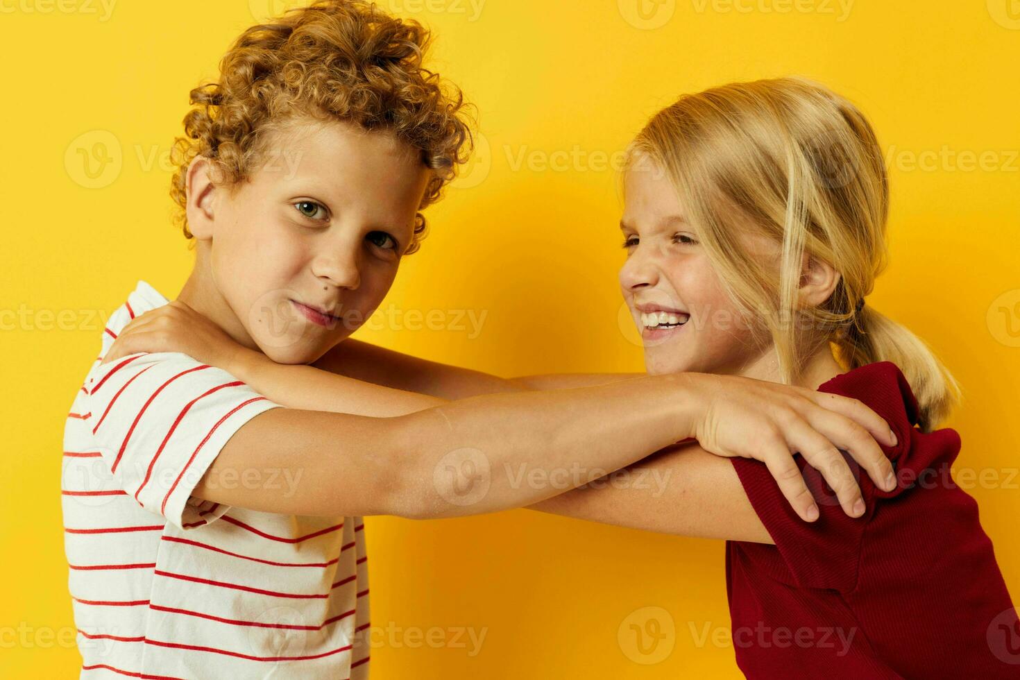 Cute preschool kids cuddling fashion childhood entertainment yellow background photo