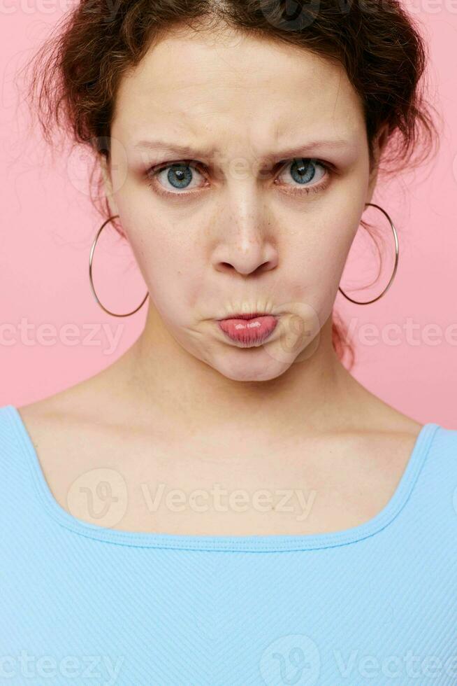 portrait of a young woman grimace close-up emotions earrings posing cropped view unaltered photo