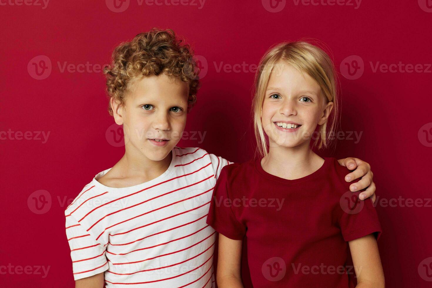 Cute stylish kids smiling and posing in casual clothes against isolated background photo