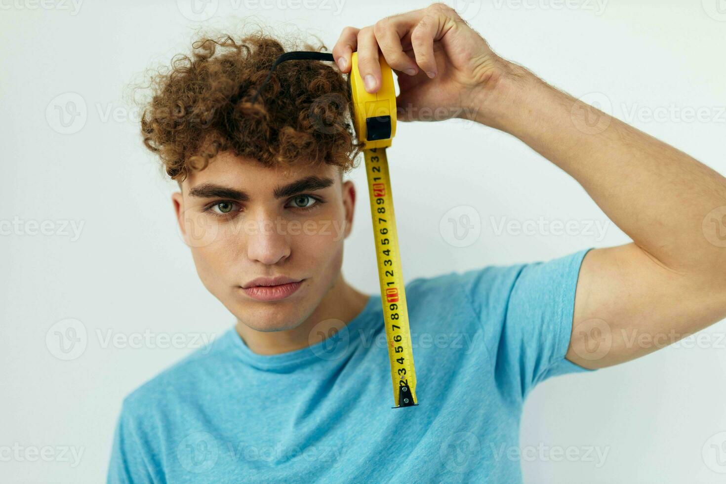 Attractive man yardstick in hand in blue t-shirts Lifestyle unaltered photo