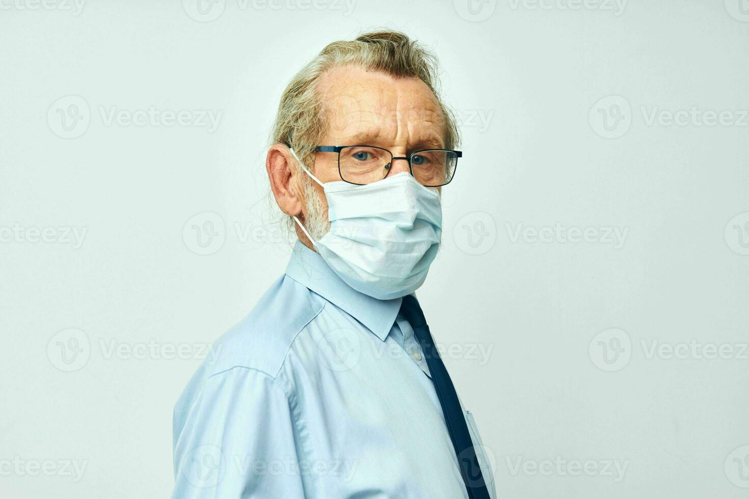 Portrait of happy senior man medical safety mask health light background photo