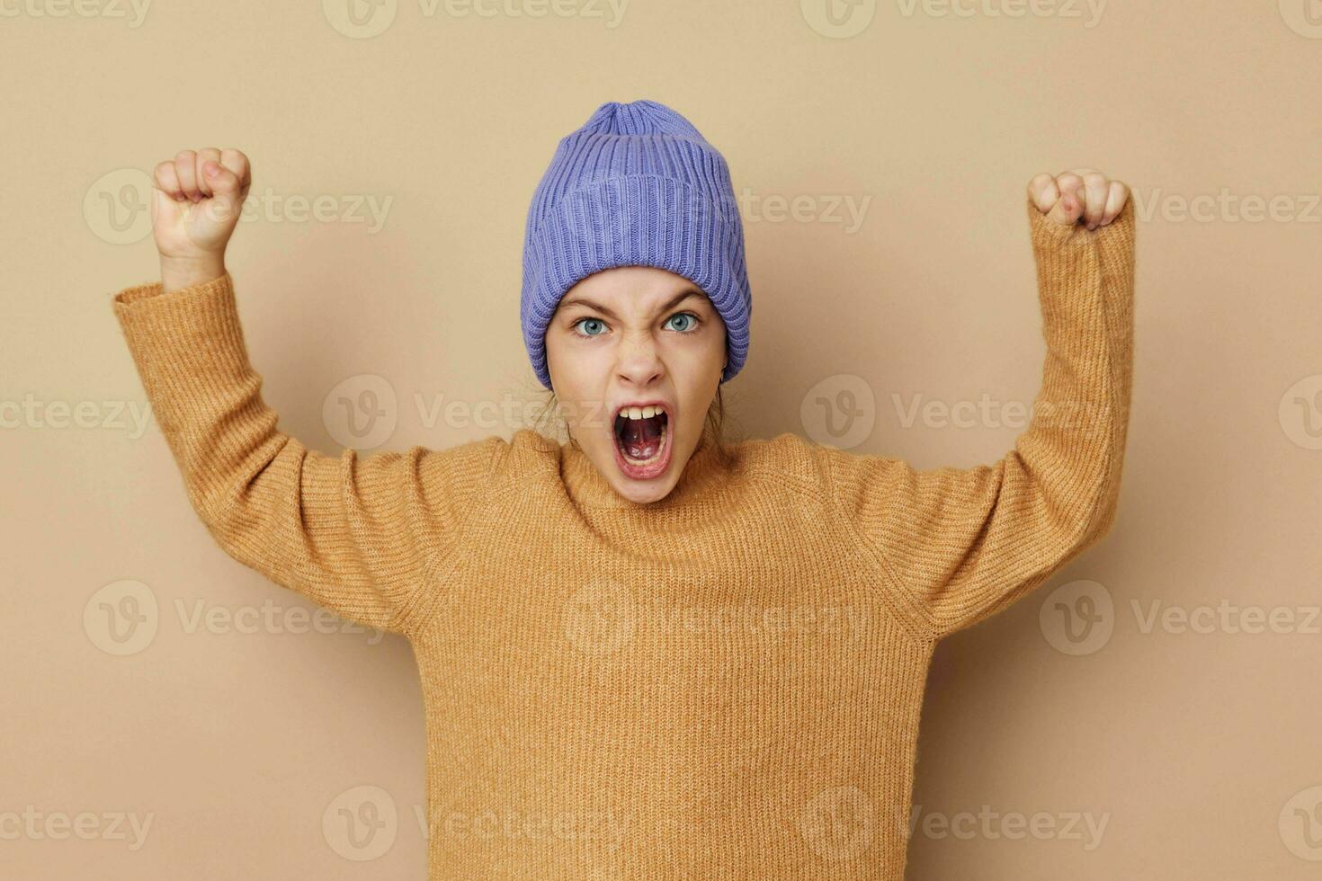 emotional girl gestures with her hands in hats photo