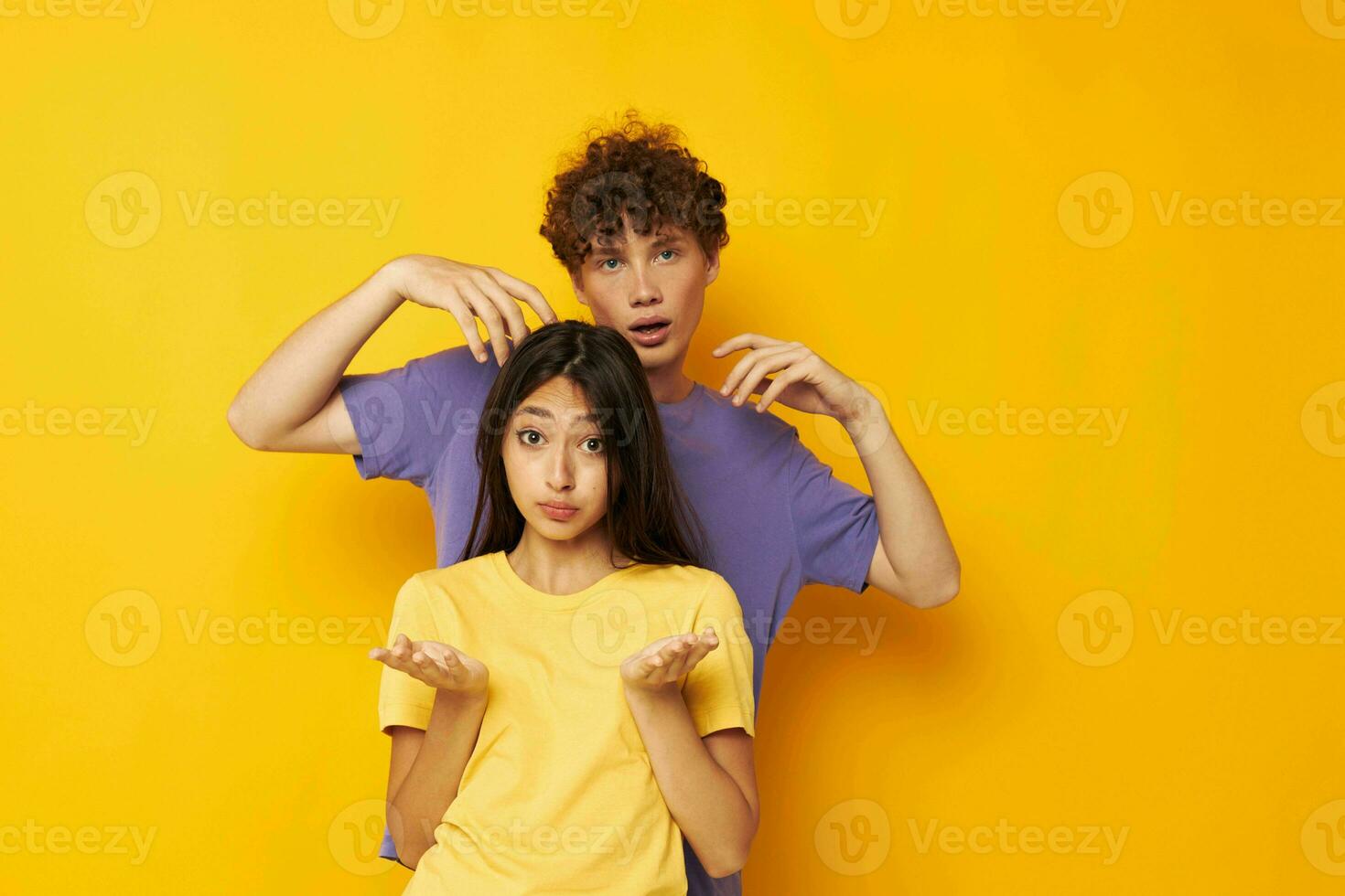 cute young couple Friendship posing fun studio yellow background unaltered photo
