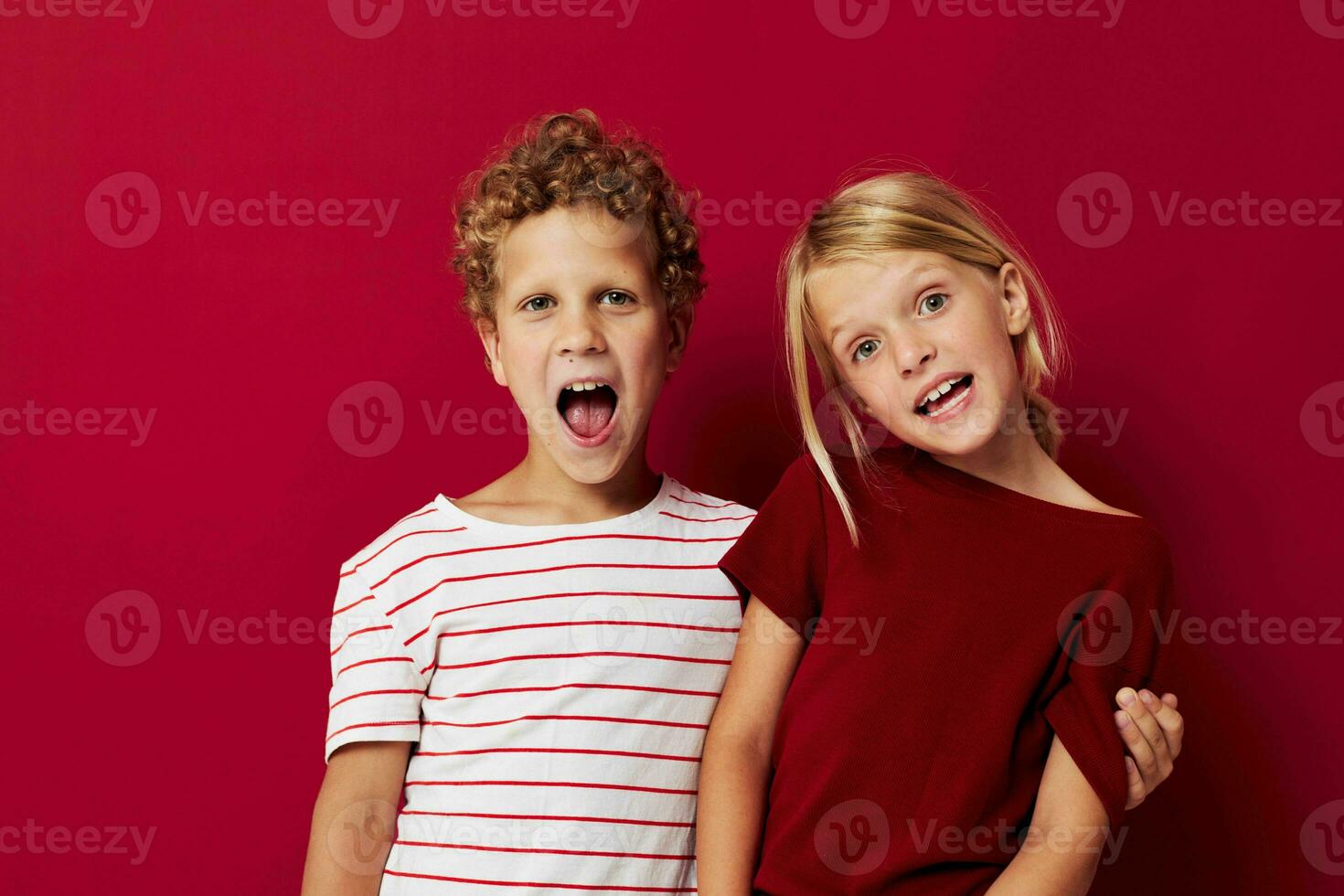 picture of positive boy and girl good mood standing next to posing isolated background photo