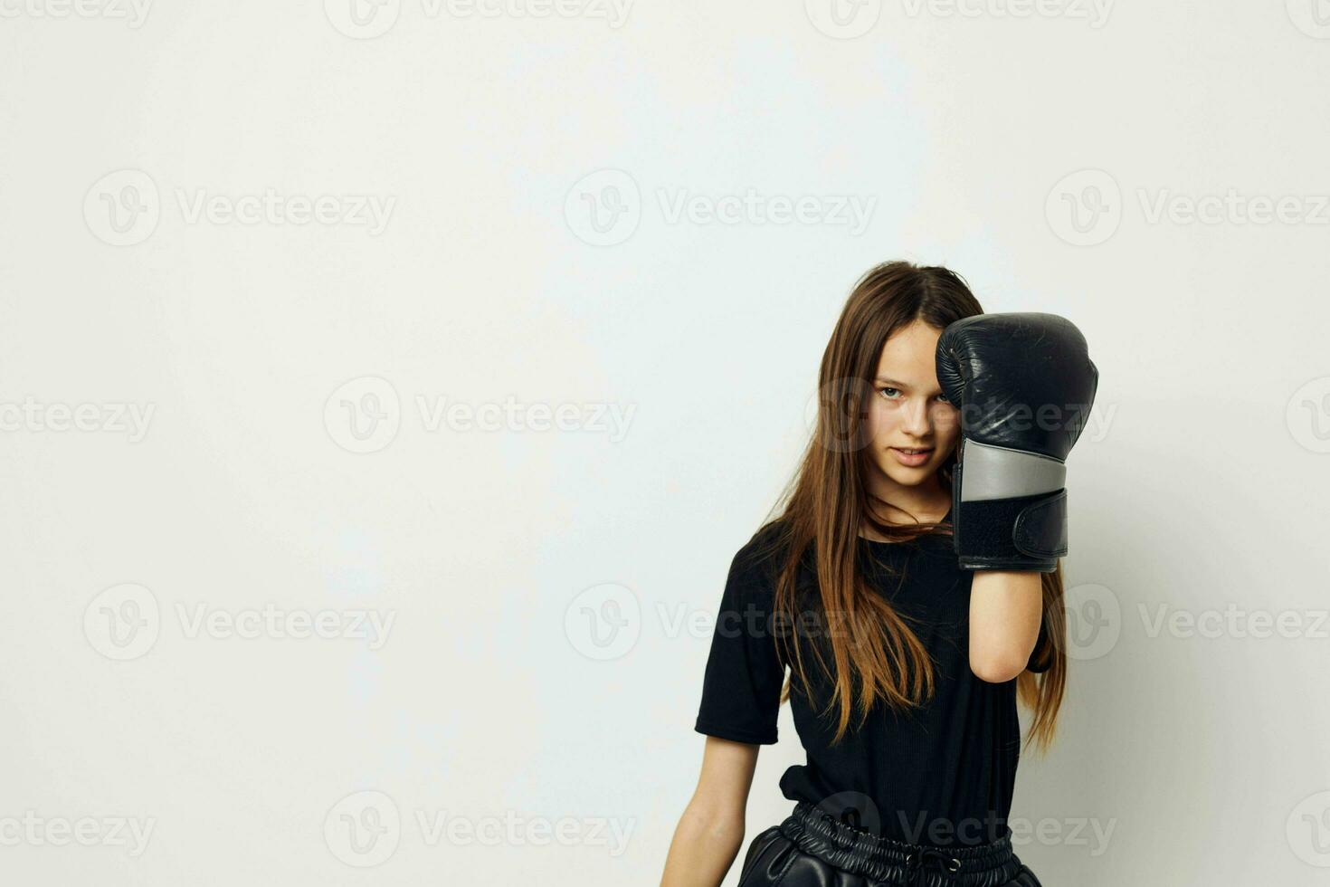 athletic woman boxing black gloves posing sports boxing punch light background photo