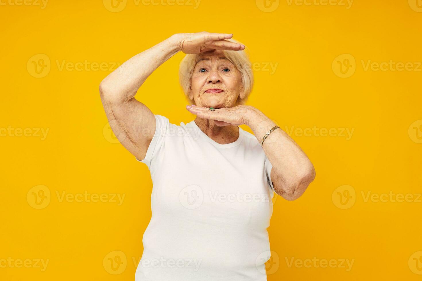 smiling elderly woman happy lifestyle joy yellow background photo