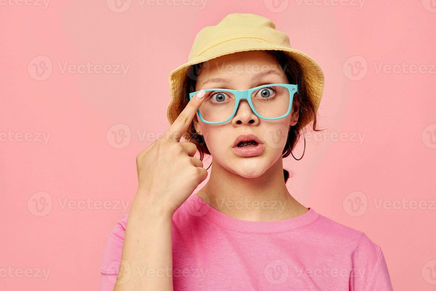 portrait of a young woman In beige Panama pink t-shirt hand gestures photo