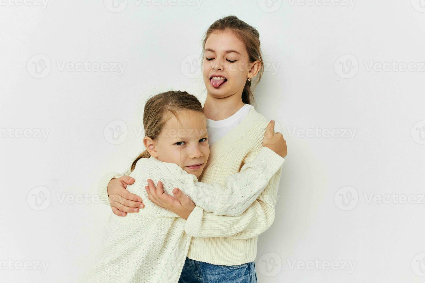 two little girls girlfriends posing light background photo