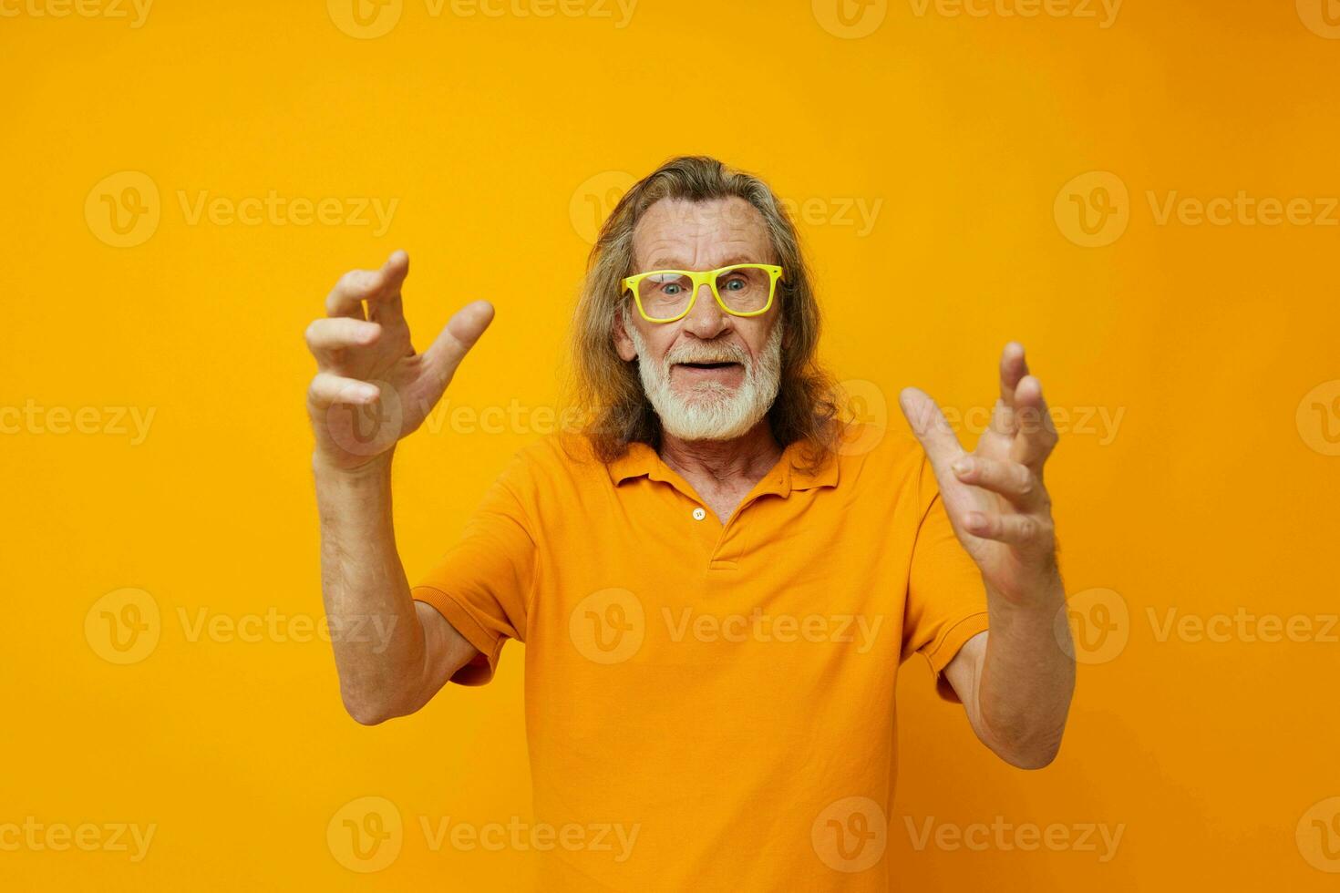 Senior grey-haired man hand gestures emotions yellow glasses monochrome shot photo