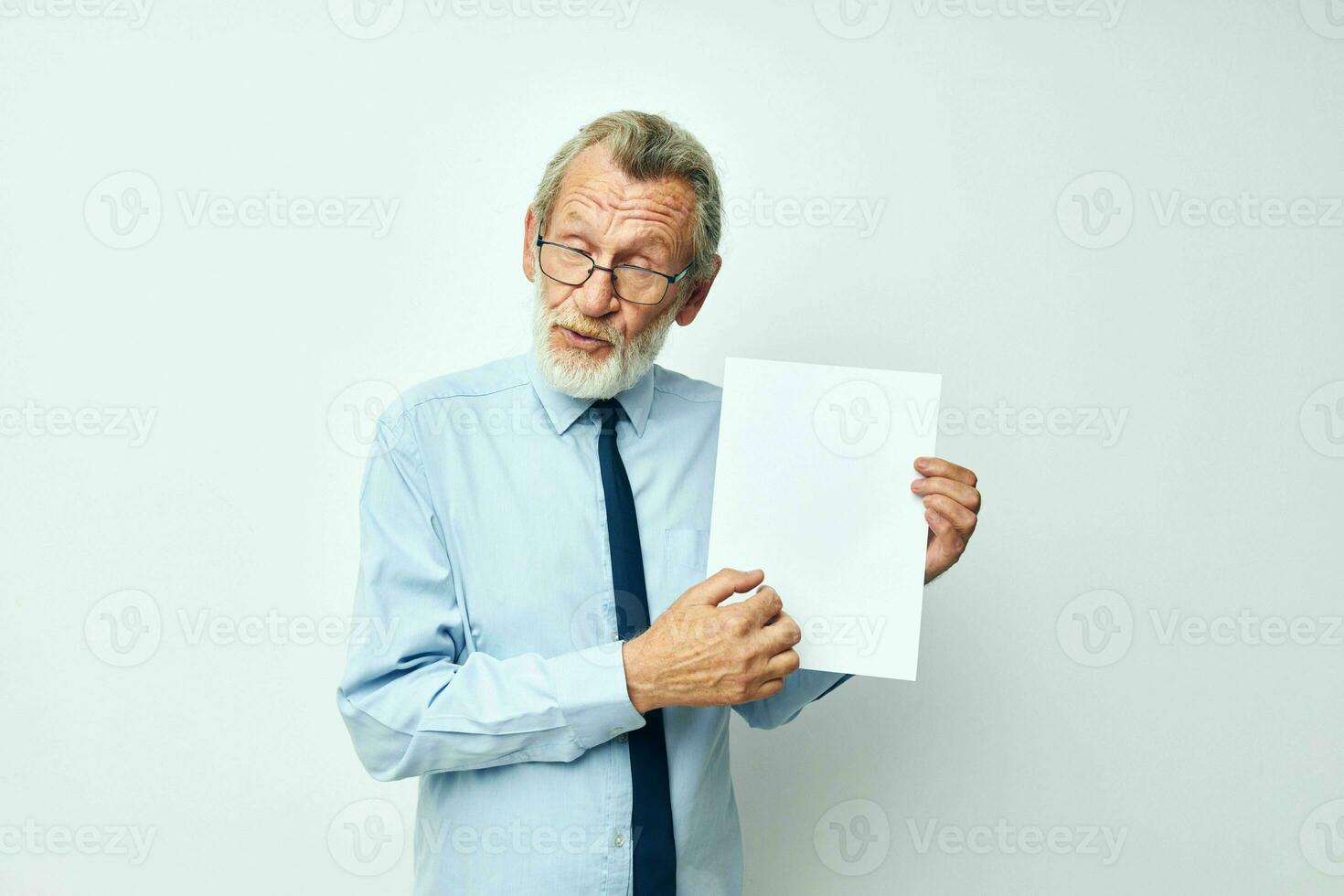 Portrait elderly man holding documents with a sheet of paper cropped view photo