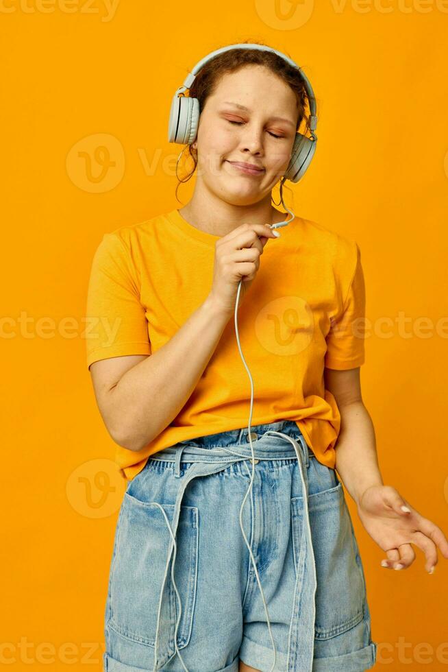 cheerful woman wearing headphones denim shorts close-up emotions isolated backgrounds unaltered photo