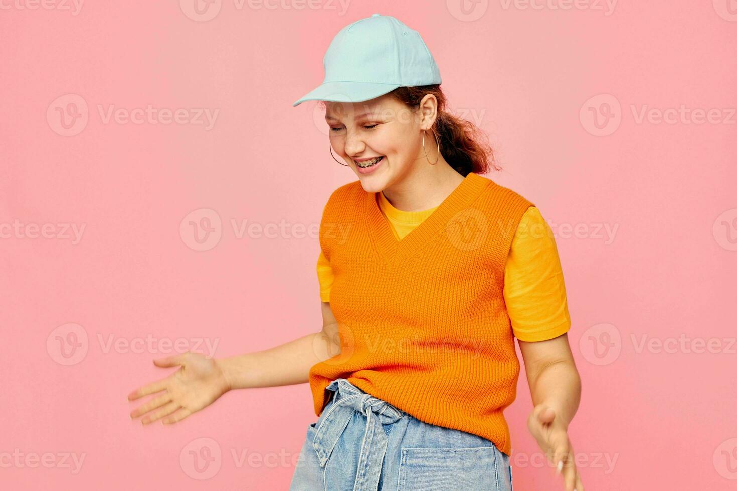 pretty girl orange sweater emotions fun isolated backgrounds unaltered photo