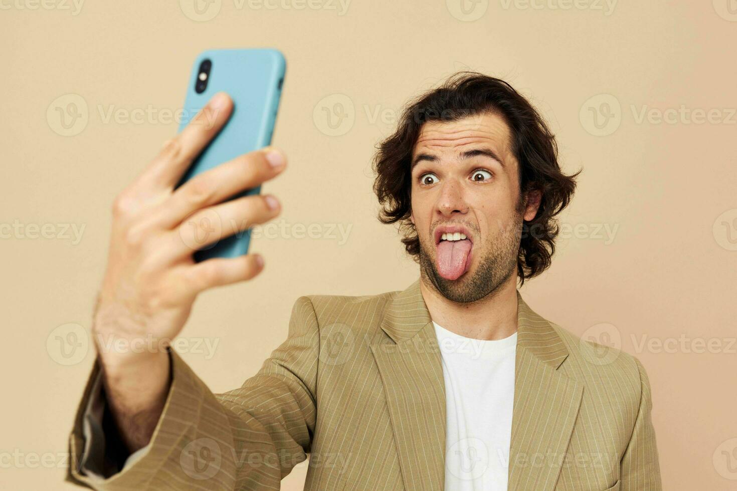 man in a suit posing emotions looking at the phone isolated background photo