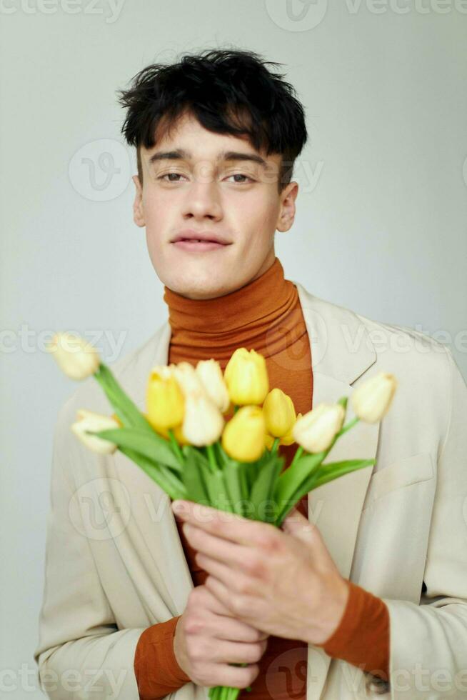 handsome guy bouquet of flowers romance fashion date isolated background unaltered photo