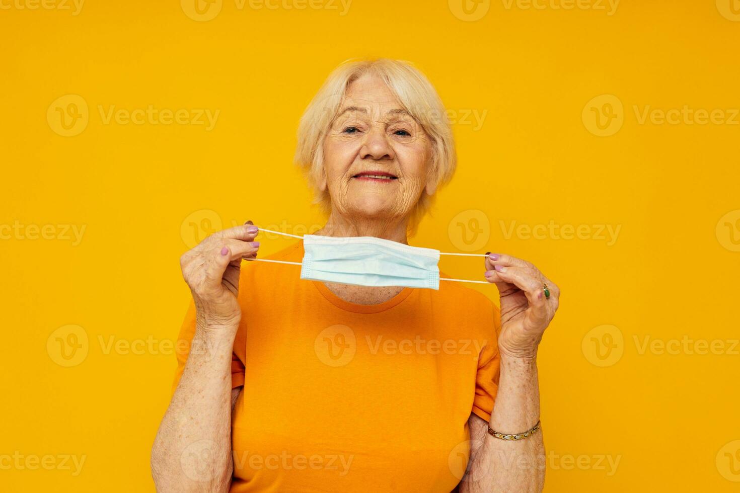 Portrait of an old friendly woman happy lifestyle medical mask close-up emotions photo