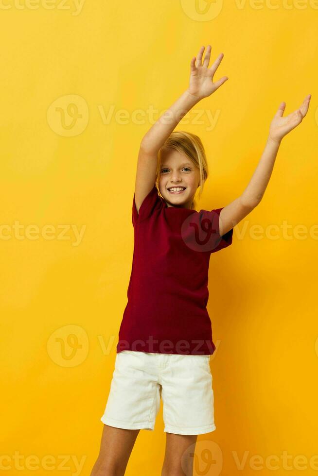 little girl sitting on the floor posing in casual clothes photo