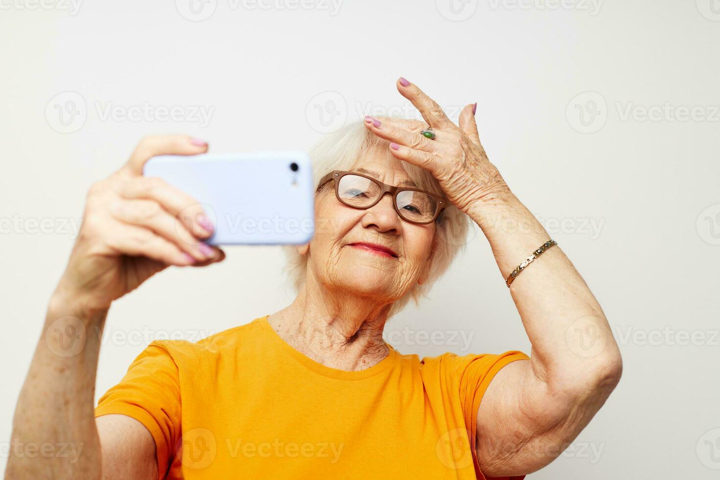 retrato de un antiguo simpático mujer contento estilo de vida en amarillo camisetas ligero antecedentes foto