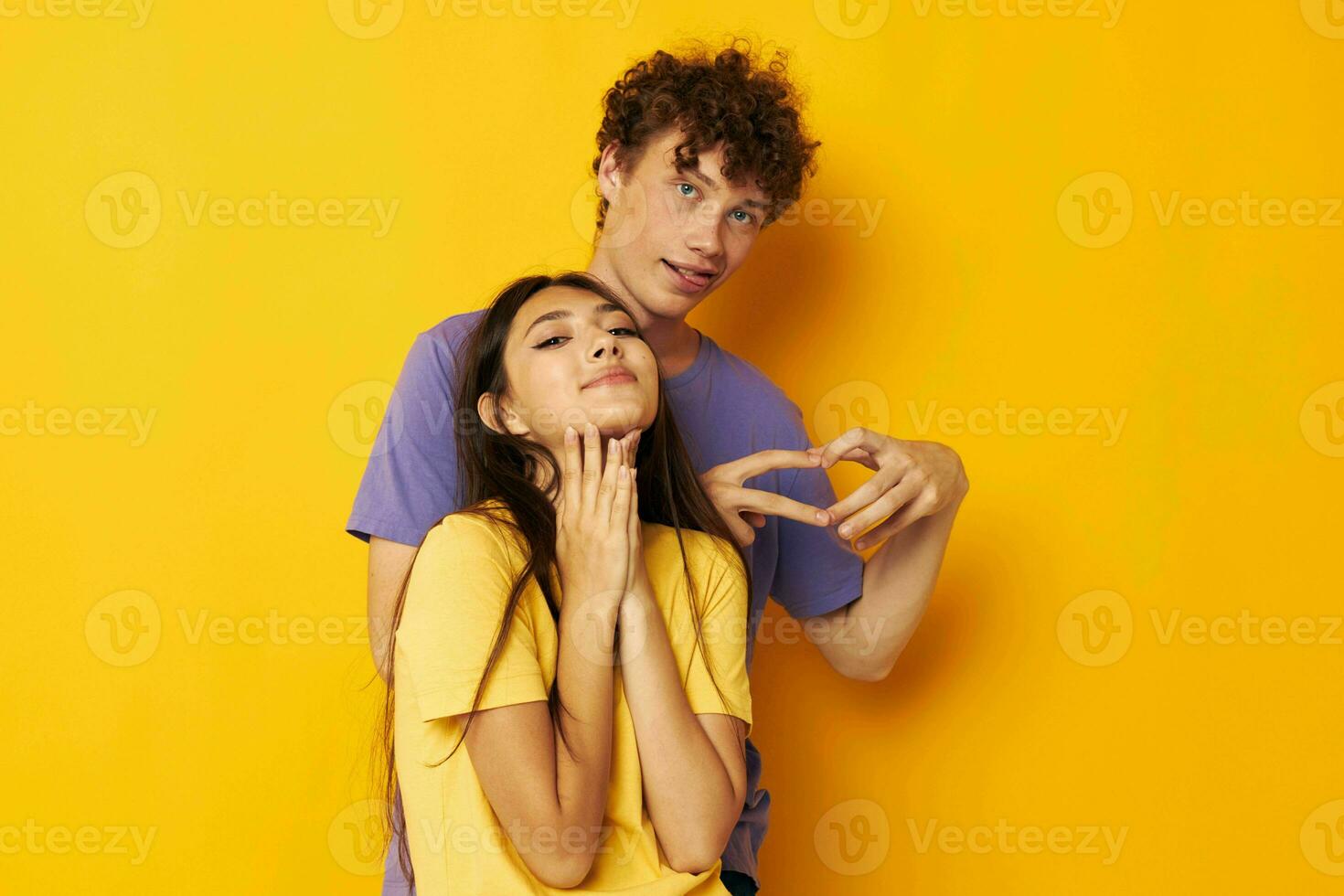 young boy and girl casual clothes posing emotions antics yellow background unaltered photo