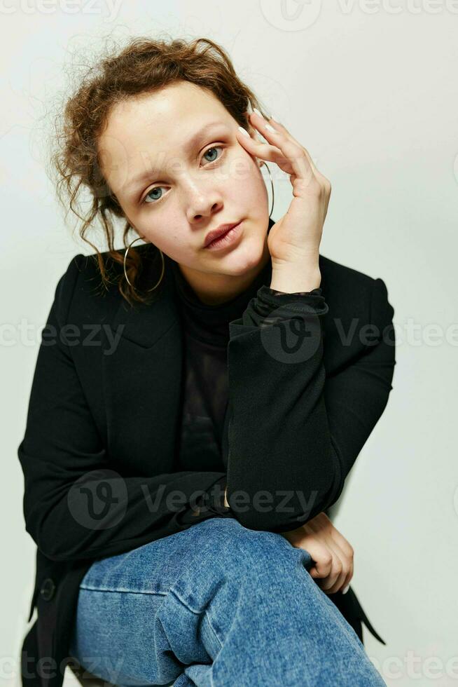 cheerful woman sitting on a chair in a black jacket fashion posing Lifestyle unaltered photo