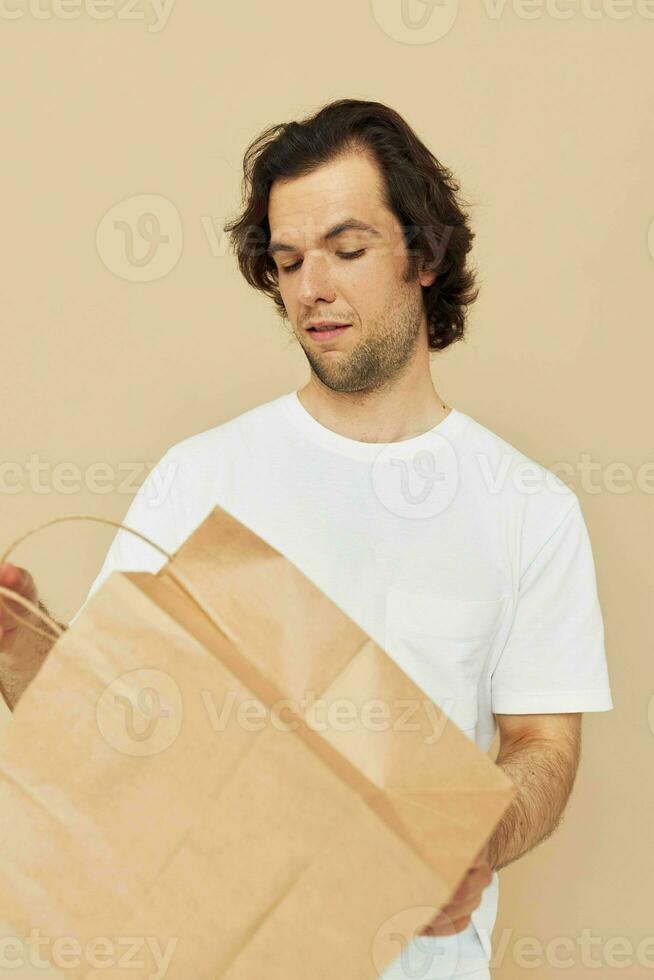 Attractive man paper bag emotions posing Lifestyle unaltered photo