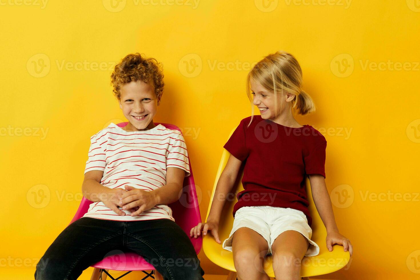 Portrait of cute children smiling and posing in casual clothes against isolated background photo