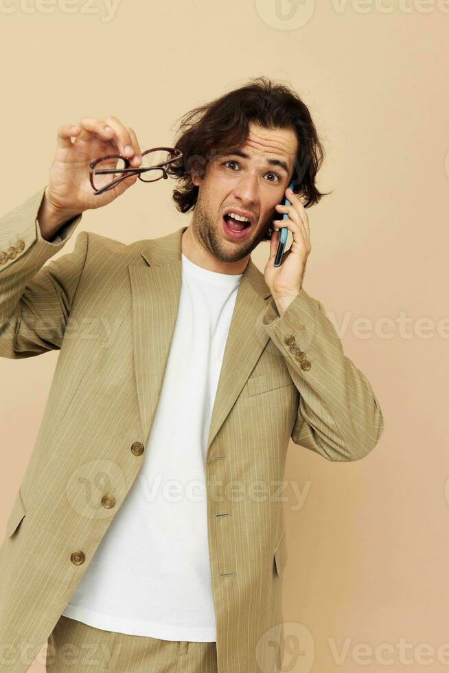 Attractive man in a suit posing emotions talking on the phone Lifestyle unaltered photo