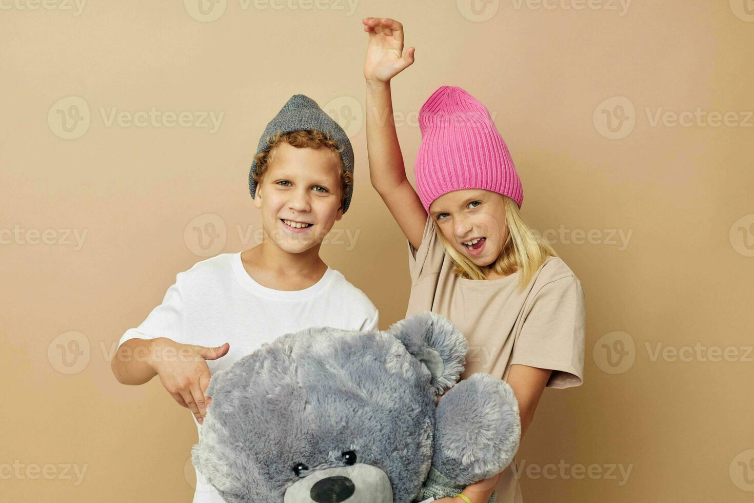 Little boy and girl in multi-colored hats entertainment posing childhood unaltered photo